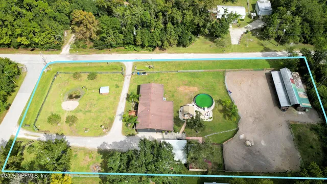 an aerial view of a house with a swimming pool