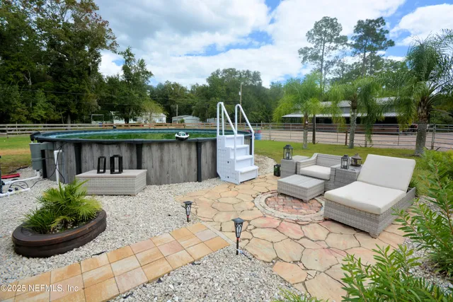 a view of a house with backyard porch and sitting area