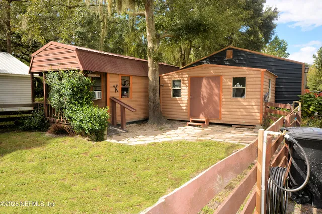 a view of a backyard with wooden fence