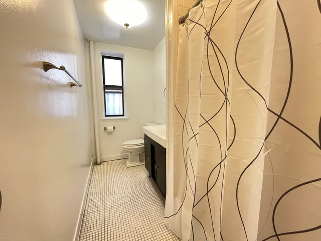 a bathroom with a toilet sink and a mirror
