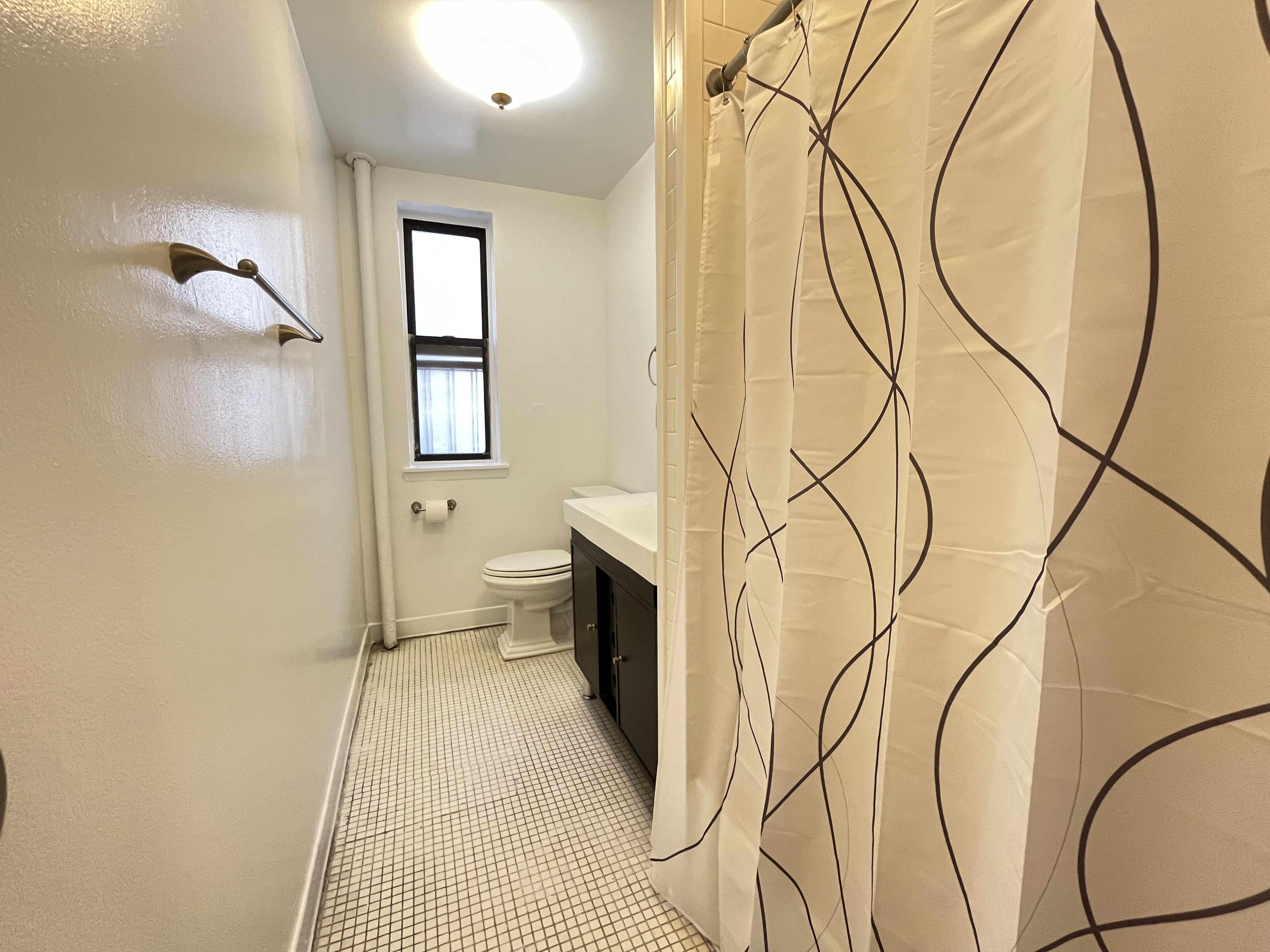 Undisclosed Address Manhattan, NY 10032 - Photo 8 of 9 a bathroom with a toilet sink and a mirror