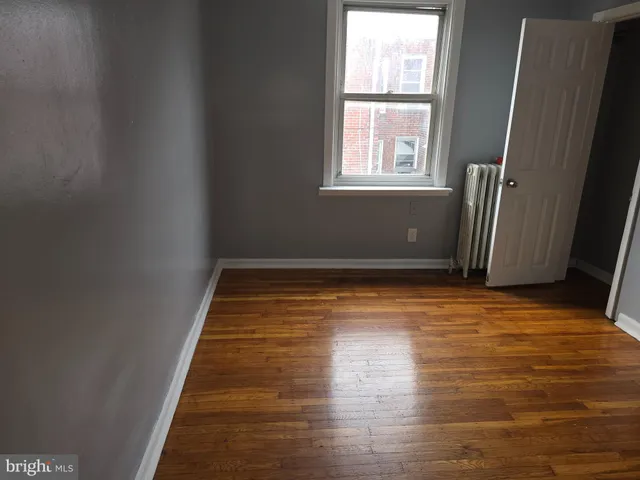 a view of room with window and wooden floor