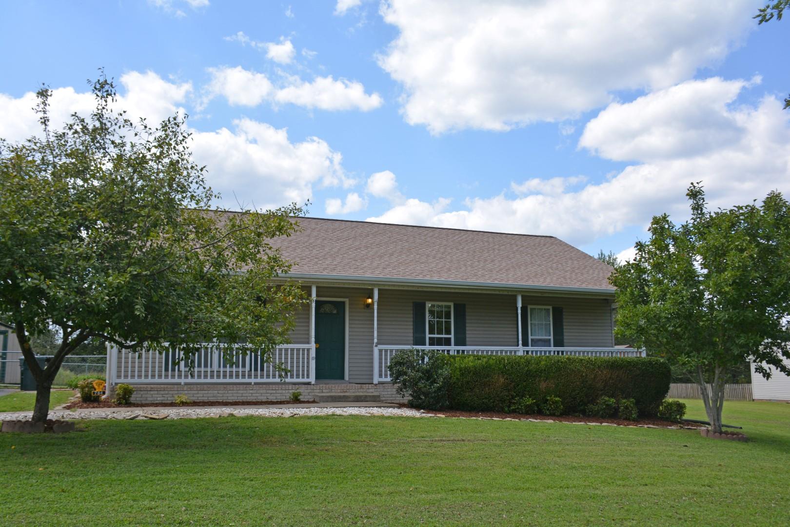784 Blakemore Road Dickson, TN 37055 - Photo 1 of 11 a front view of a house with a garden and trees