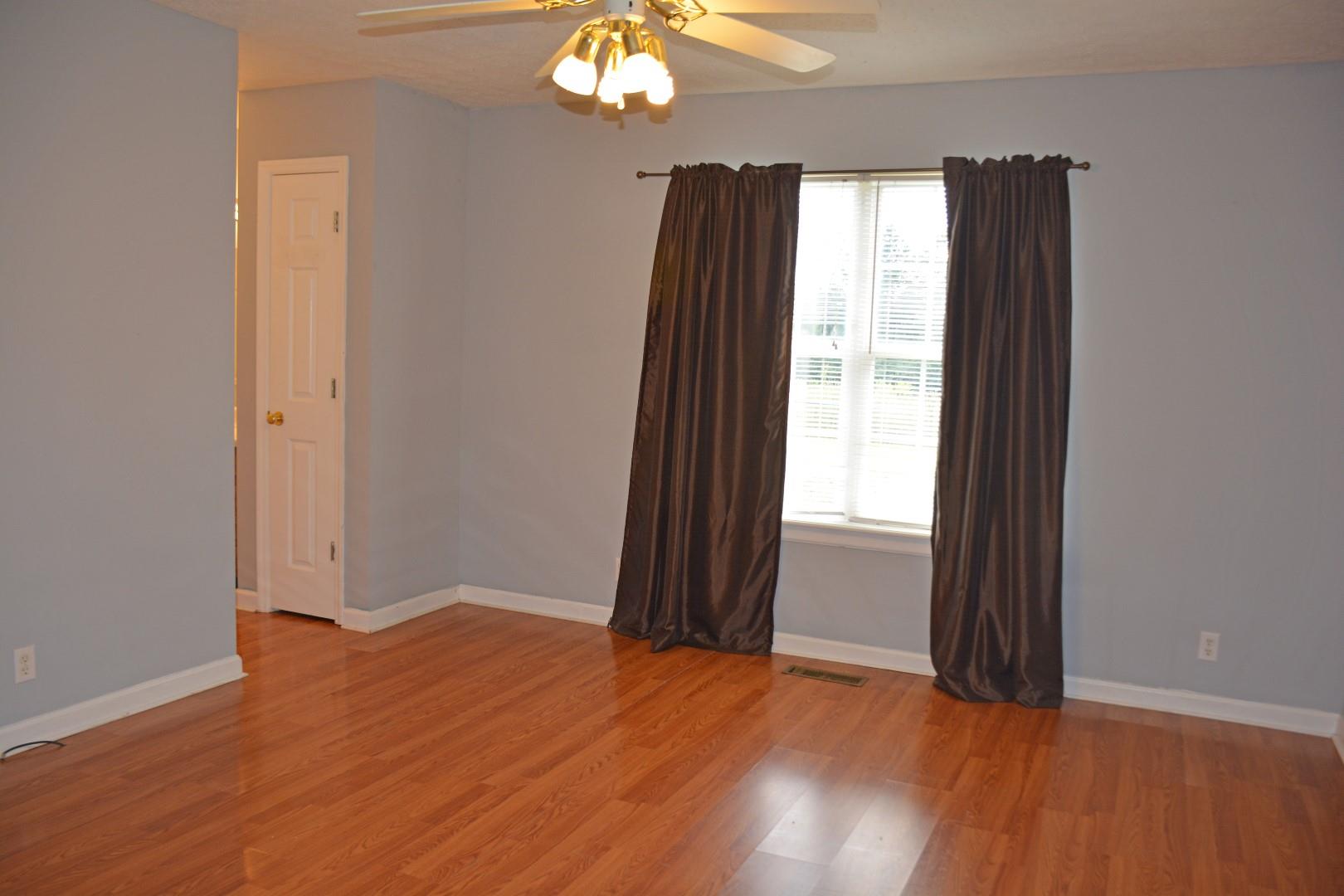 784 Blakemore Road Dickson, TN 37055 - Photo 8 of 11 an empty room with wooden floor and windows