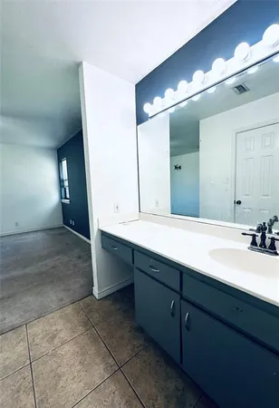 a bathroom with a double vanity sink and a mirror