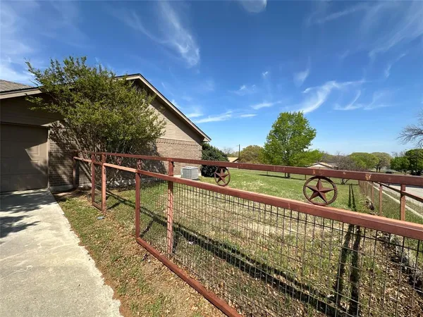 a view of a balcony with wooden floor and fence