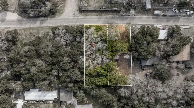 an aerial view of a house with a yard and lake view