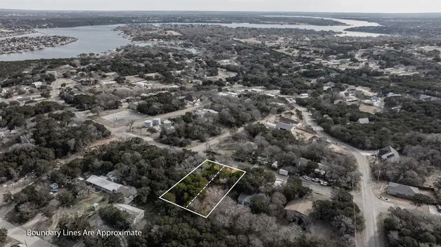 an aerial view of house with yard and mountain view in back