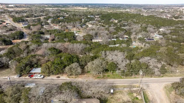 an aerial view of road with trees