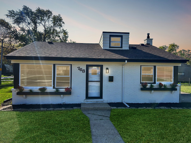 768 North Rohde Avenue Hillside, IL 60162 - Photo 1 of 20 a front view of a house with a garden and yard