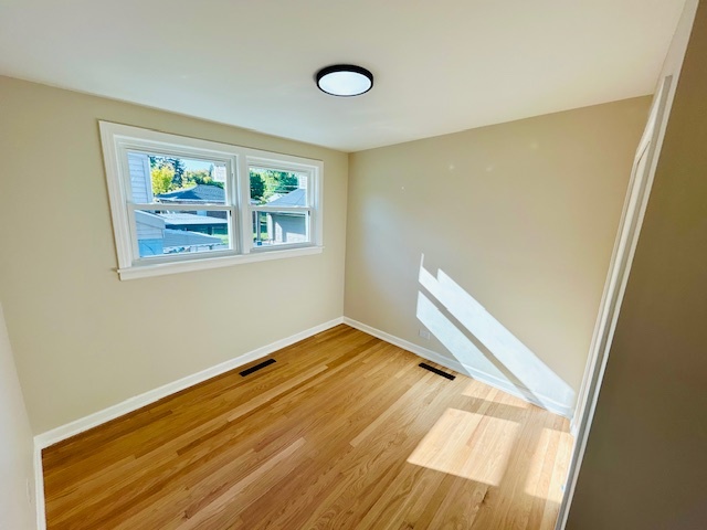 768 North Rohde Avenue Hillside, IL 60162 - Photo 12 of 20 a view of an empty room with wooden floor and a window