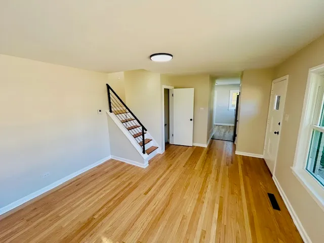 a view of a room with wooden floor and staircase