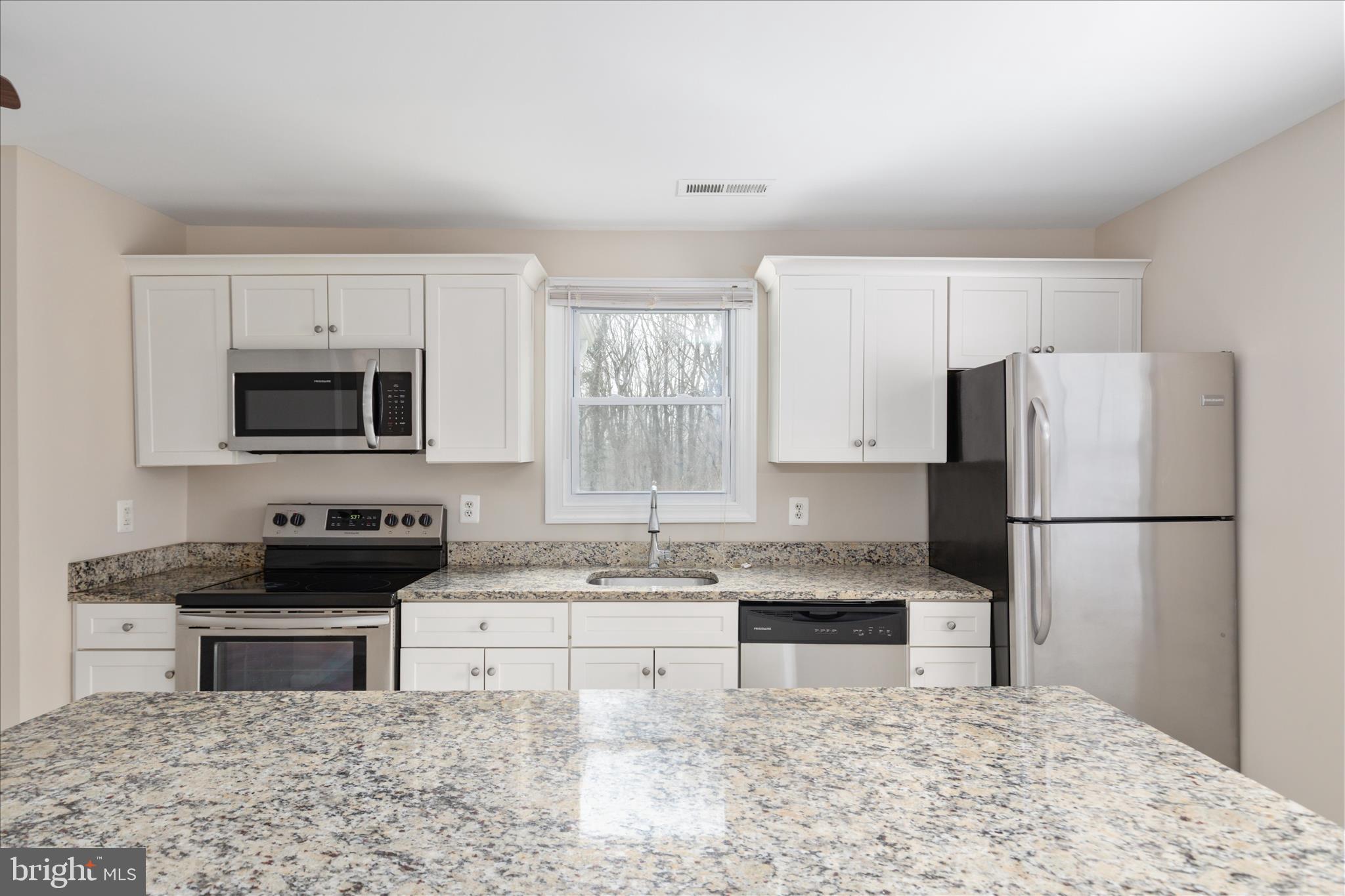 6533 Caledon Road King George, VA 22485 - Photo 11 of 32 a kitchen with a stove a sink and a refrigerator