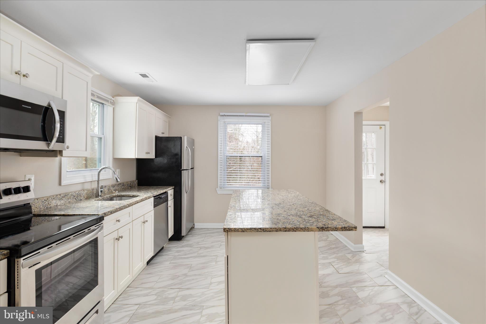 6533 Caledon Road King George, VA 22485 - Photo 12 of 32 a kitchen with a sink stove and refrigerator