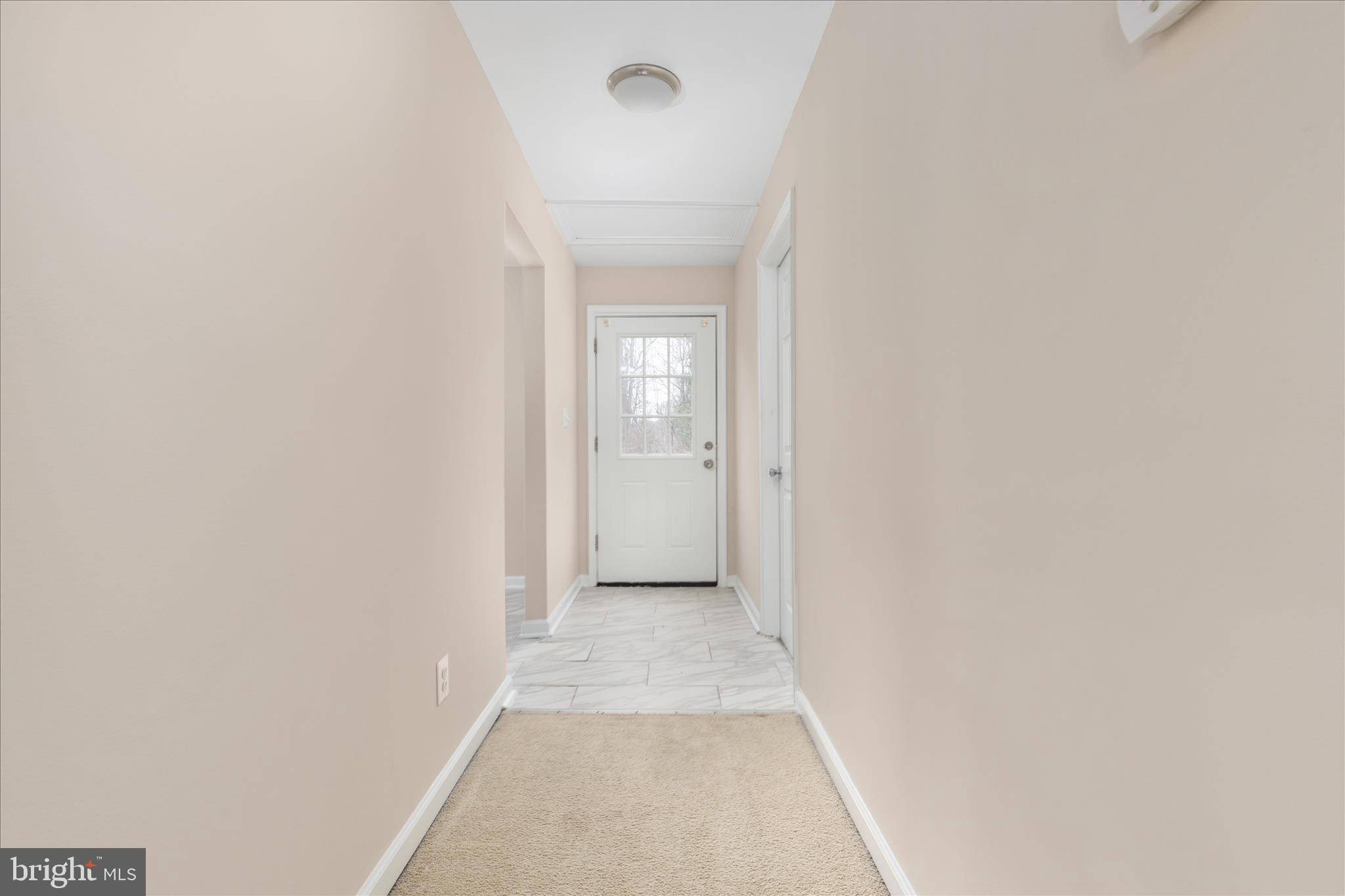 6533 Caledon Road King George, VA 22485 - Photo 13 of 32 a view of a hallway with wooden floor and a bathroom