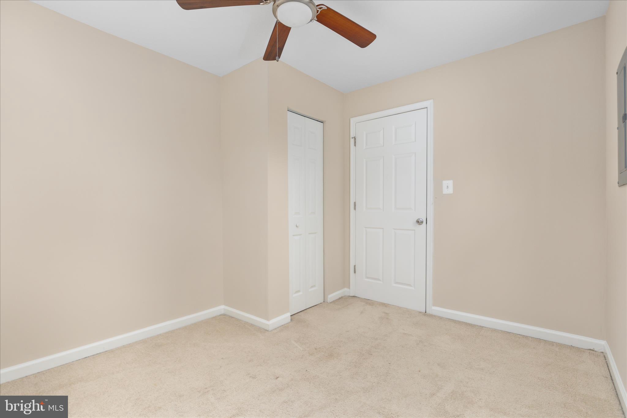 6533 Caledon Road King George, VA 22485 - Photo 15 of 32 an empty room with a ceiling fan and carpet