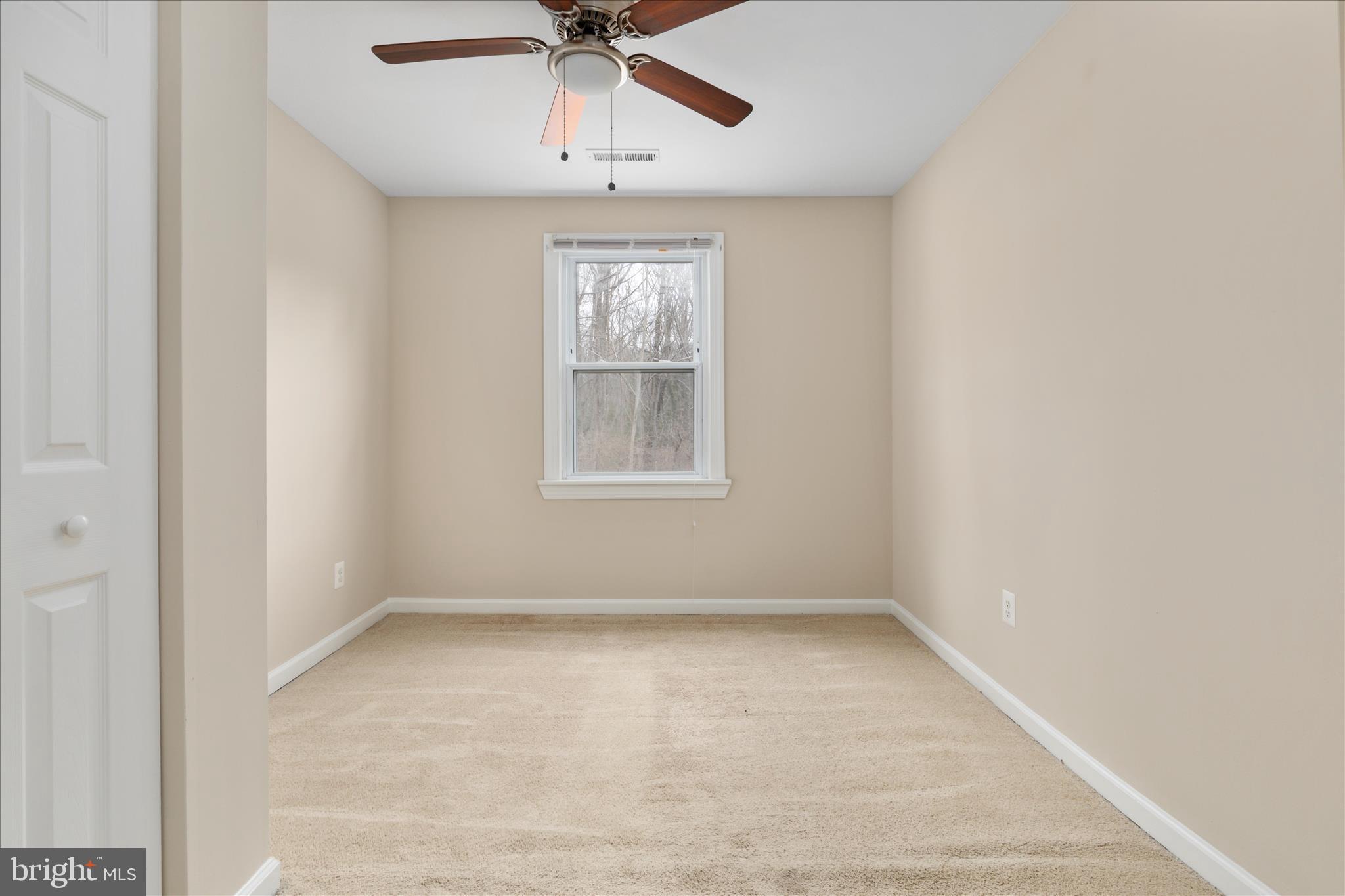 6533 Caledon Road King George, VA 22485 - Photo 16 of 32 an empty room with a window and ceiling fan