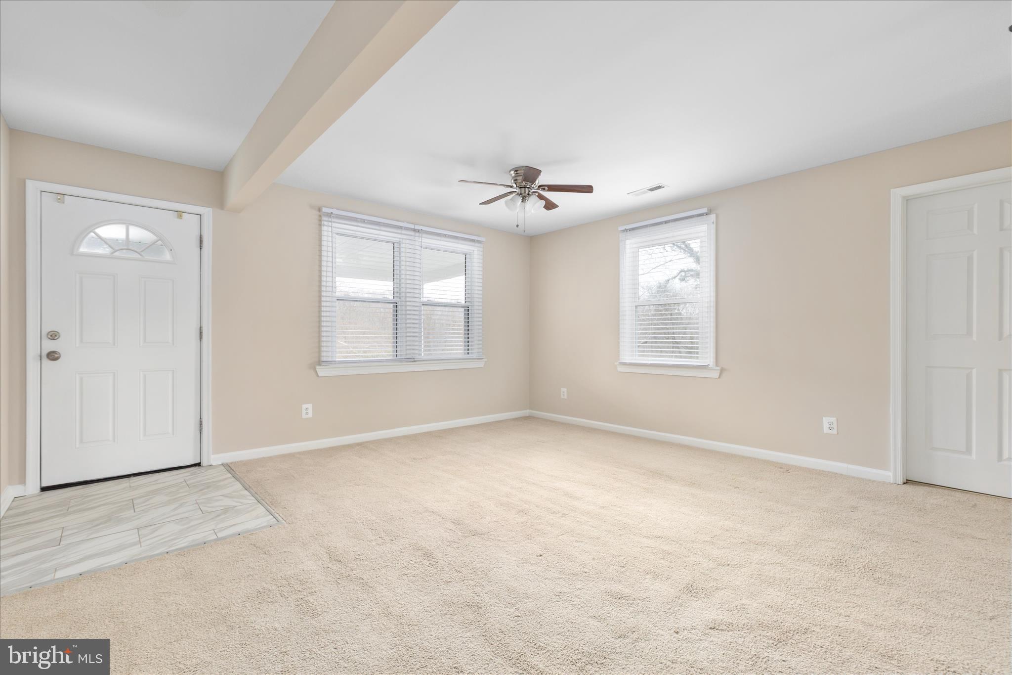 6533 Caledon Road King George, VA 22485 - Photo 5 of 32 an empty room with windows and ceiling fan