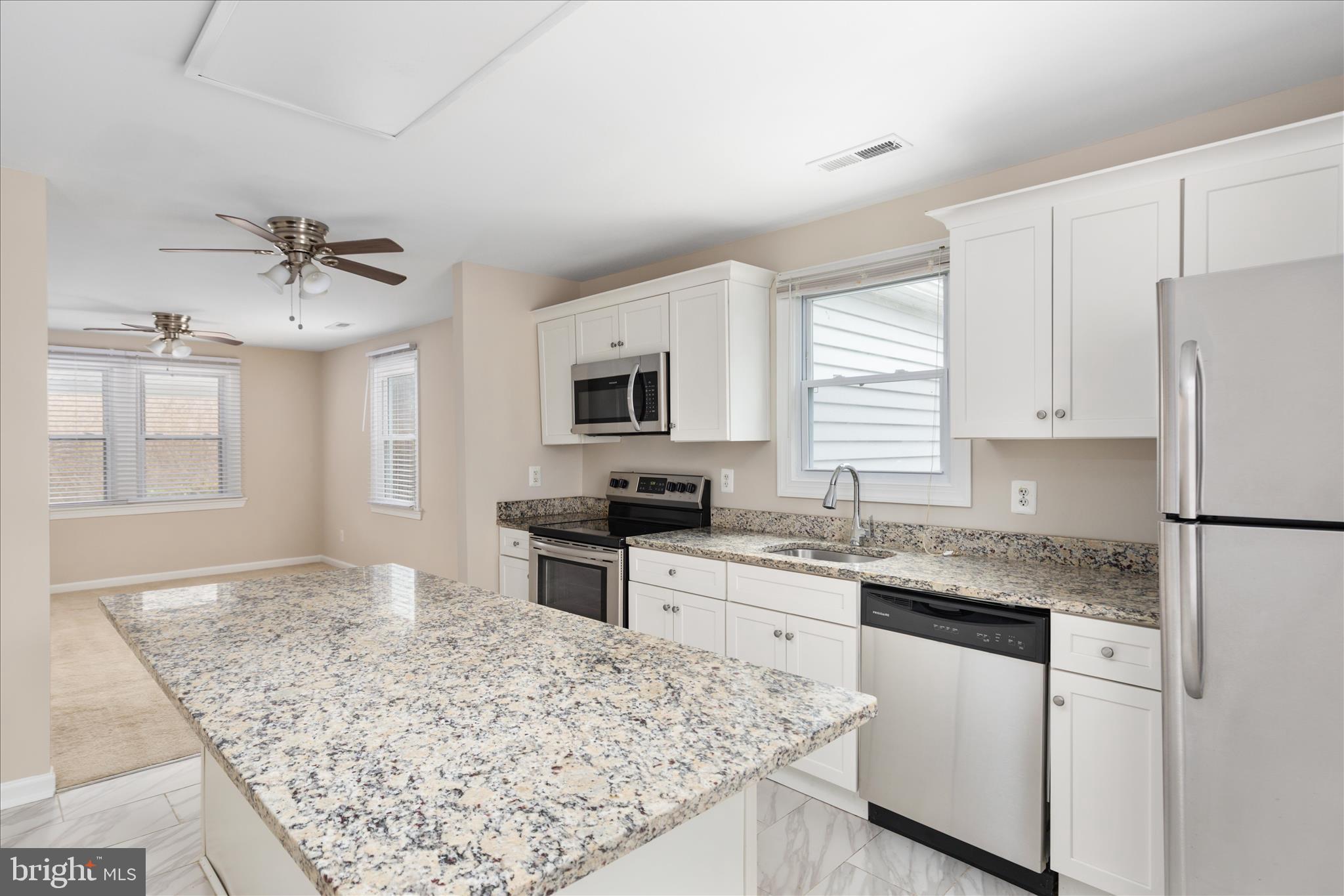 6533 Caledon Road King George, VA 22485 - Photo 9 of 32 a kitchen with stainless steel appliances granite countertop refrigerator sink and cabinets