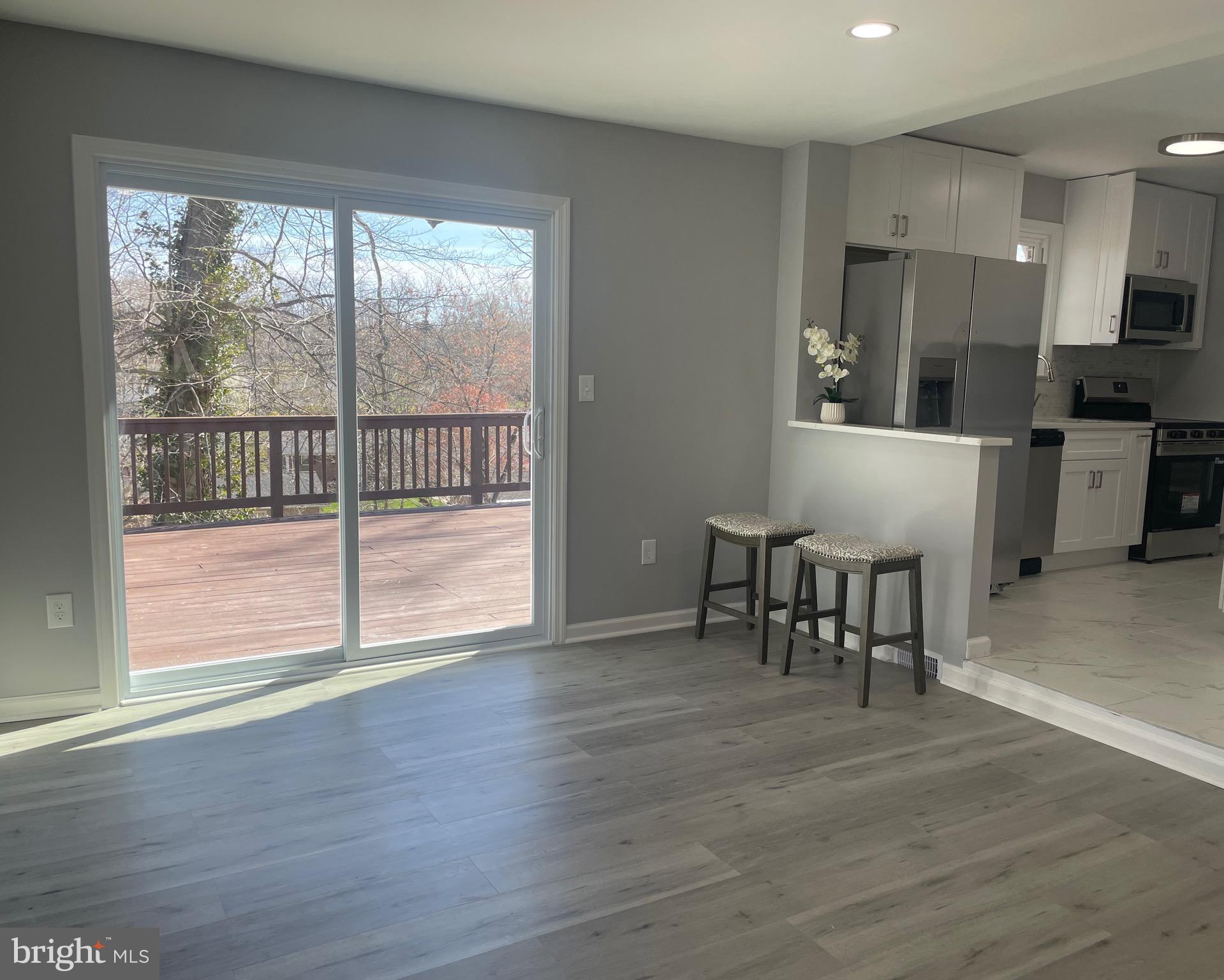 6107 Buckler Road Clinton, MD 20735 - Photo 9 of 45 a view of a kitchen with dining room and wooden floor