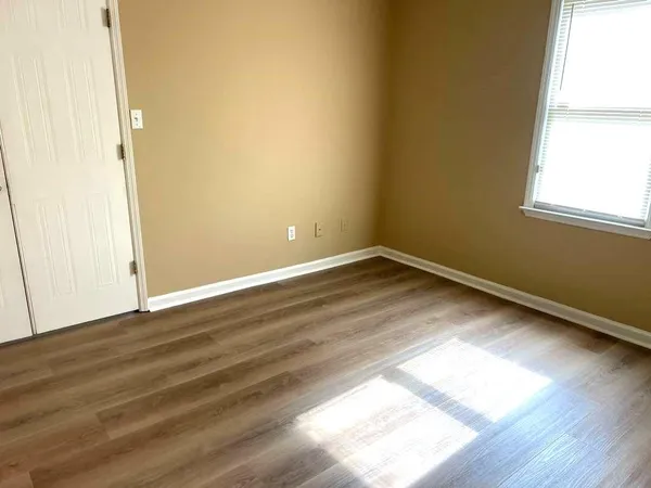a view of an empty room and wooden floor