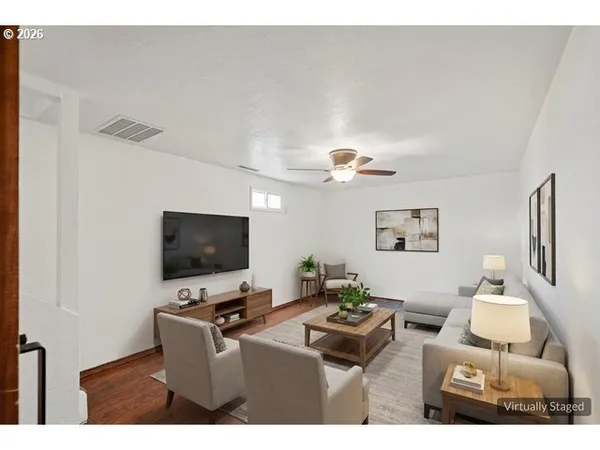 a living room with furniture and a flat screen tv