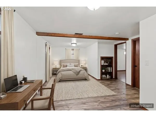 a bedroom with a bed and a desk