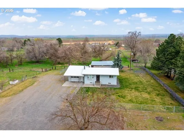a white bench sitting in the middle of a big yard
