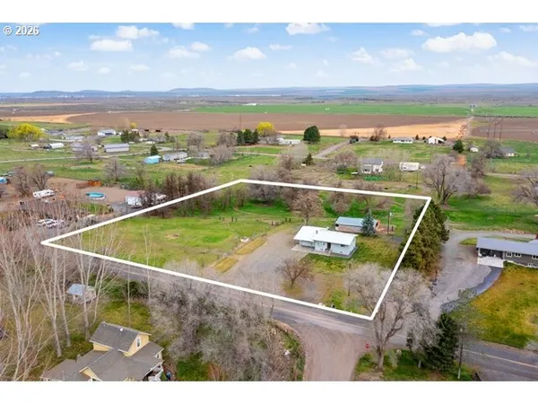 an aerial view of residential houses with outdoor space and ocean view