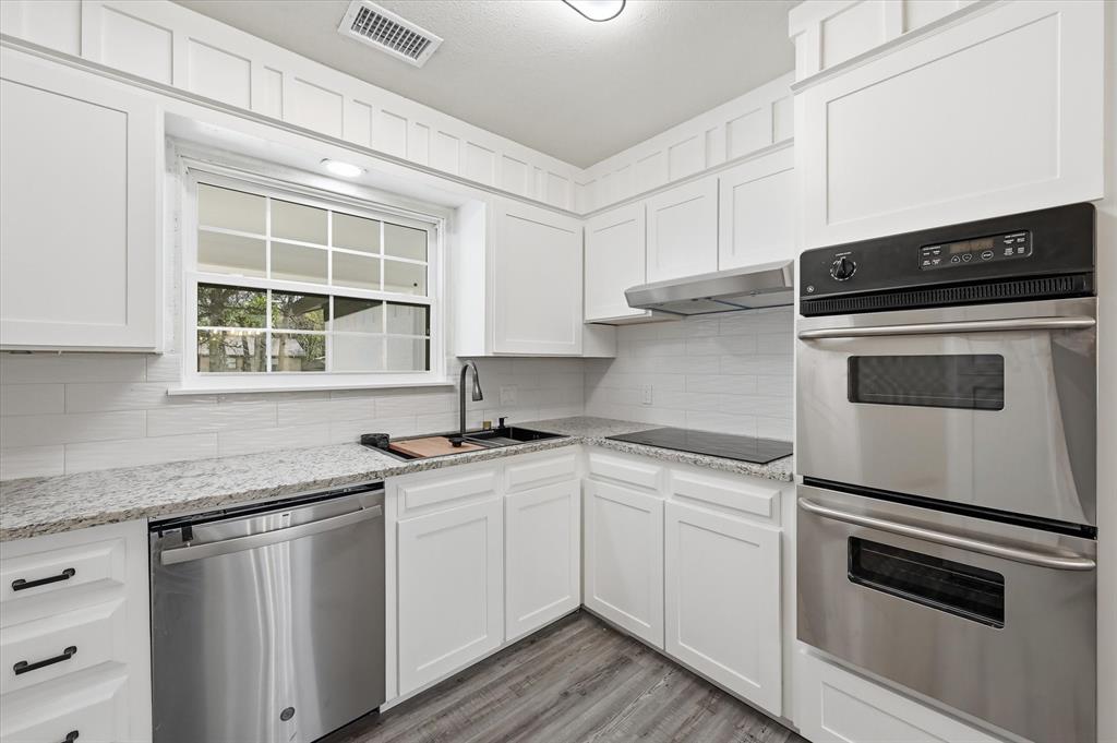 2804 Bent Tree Lane Arlington, TX 76016 - Photo 10 of 32 a kitchen with granite countertop stainless steel appliances white cabinets sink and dishwasher