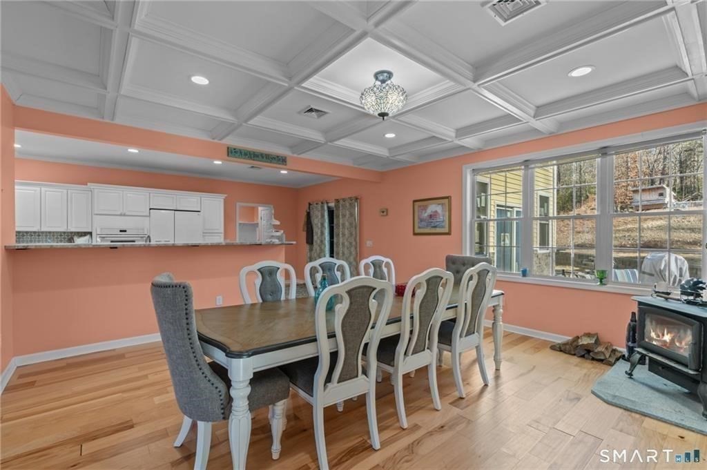 117 New Road Thompson, CT 06277 - Photo 14 of 29 a dining room with furniture a rug and wooden floor