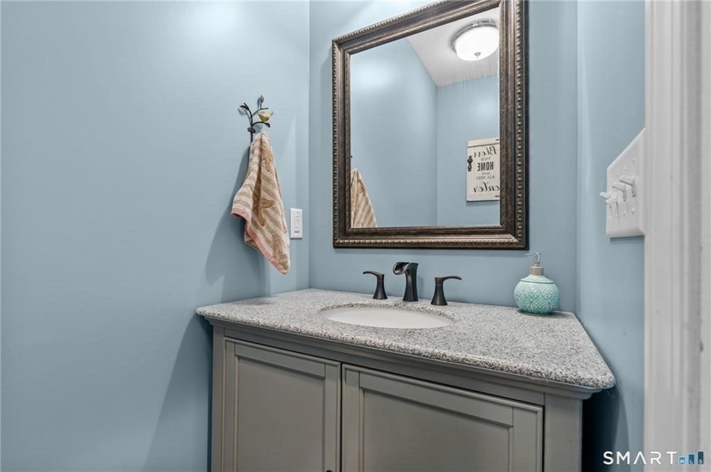 117 New Road Thompson, CT 06277 - Photo 18 of 29 a bathroom with a granite countertop sink and a mirror