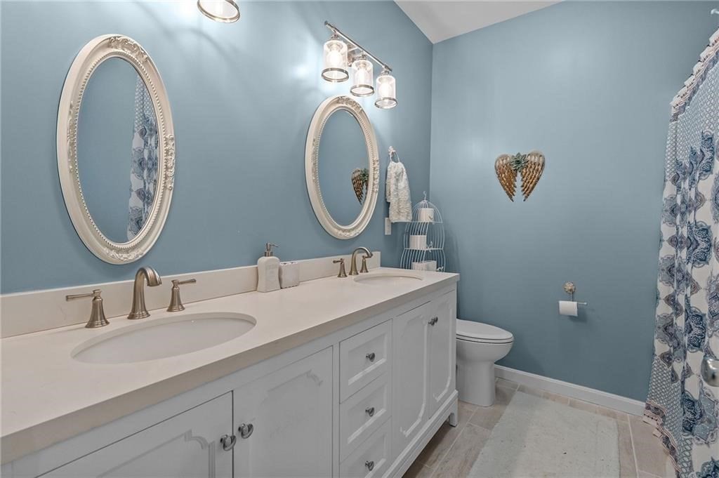 117 New Road Thompson, CT 06277 - Photo 19 of 29 a bathroom with a double vanity sink and a mirror