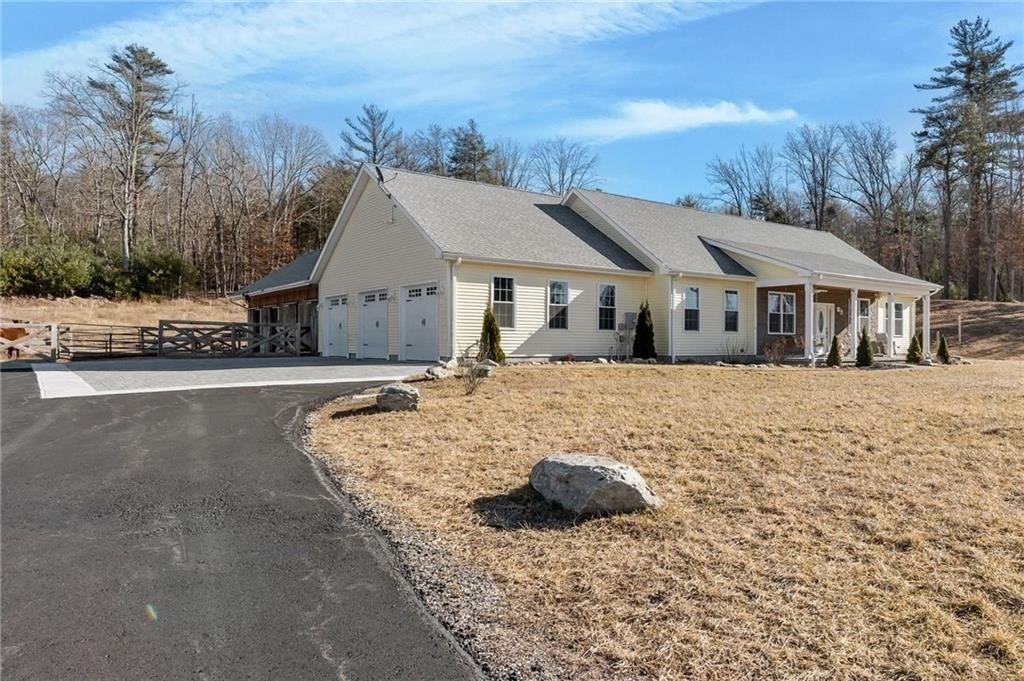 117 New Road Thompson, CT 06277 - Photo 2 of 29 a front view of a house with a yard