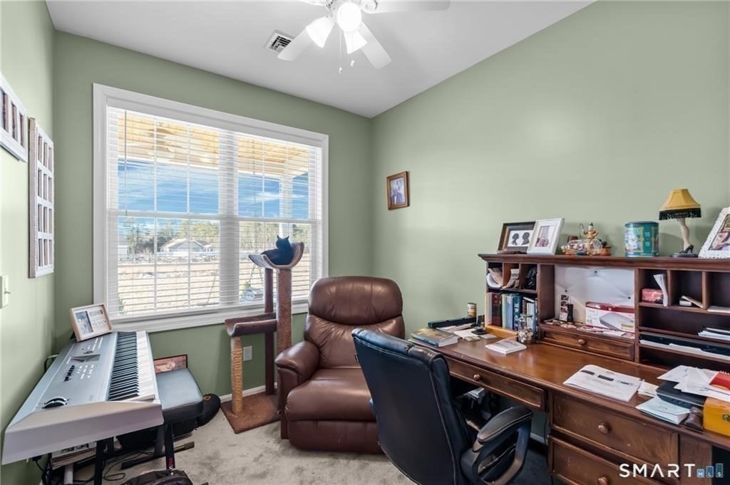 117 New Road Thompson, CT 06277 - Photo 22 of 29 a view of a workspace with furniture and a window