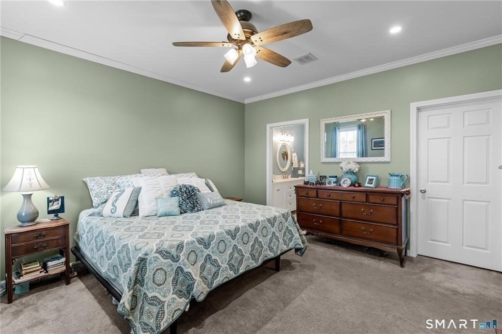 117 New Road Thompson, CT 06277 - Photo 23 of 29 a bedroom with a bed and a chandelier