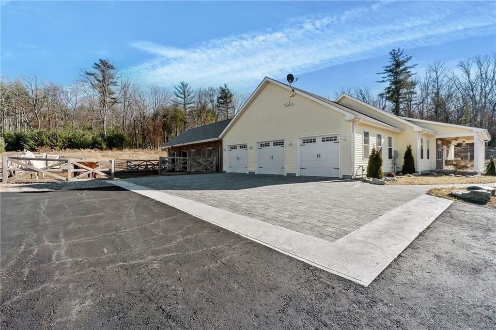 117 New Road Thompson, CT 06277 - Photo 28 of 29 a view of the house and car parked on the road