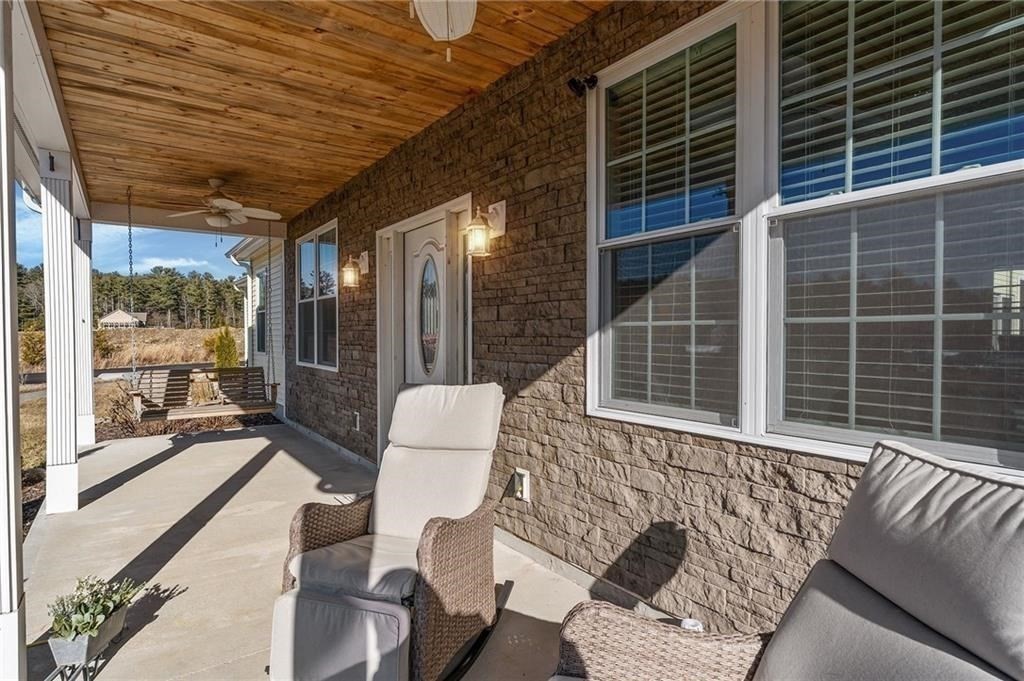 117 New Road Thompson, CT 06277 - Photo 5 of 29 a view of a patio with couches chairs and wooden floor