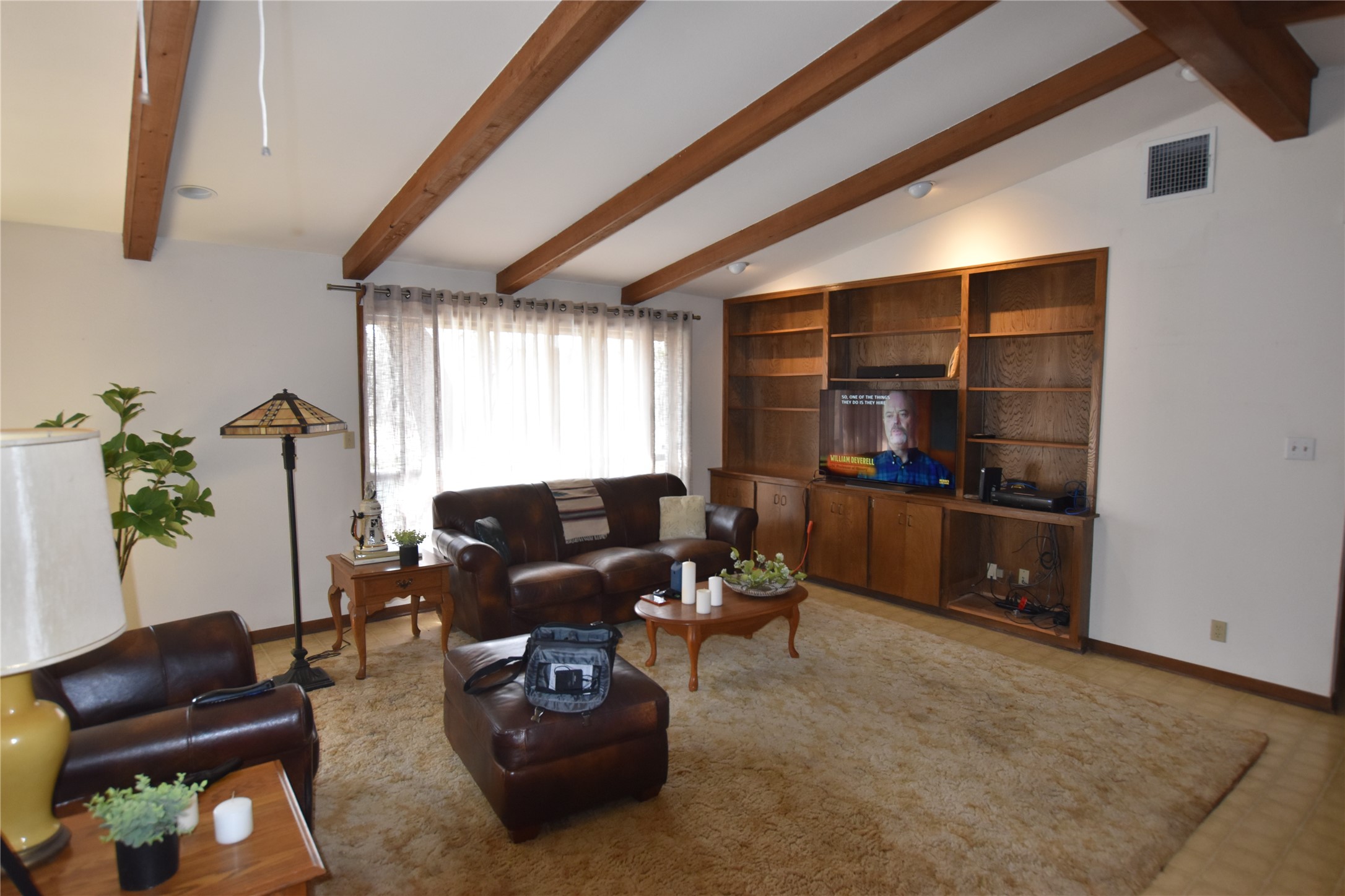 687 Fm 812 Road Red Rock, TX 78662 - Photo 11 of 40 Living area featuring vaulted ceiling with beams and light flooring
