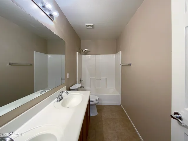 a bathroom with a sink and mirror with toilet