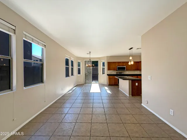 a large white kitchen with a sink and cabinets