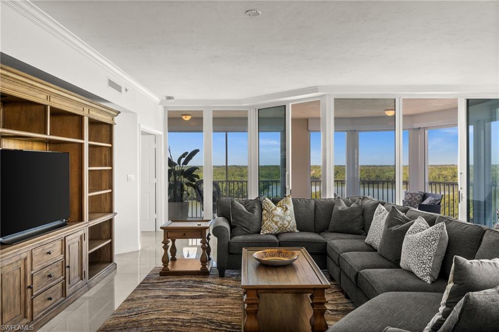 445 Dockside Drive, Unit A504 Naples, FL 34110 - Photo 12 of 50 a living room with furniture tv and large window