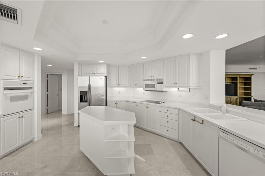 445 Dockside Drive, Unit A504 Naples, FL 34110 - Photo 17 of 50 a large white kitchen with cabinets