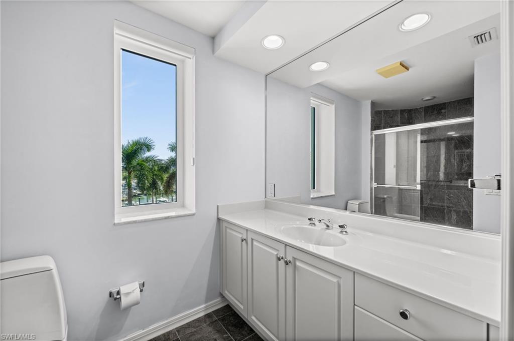 445 Dockside Drive, Unit A504 Naples, FL 34110 - Photo 22 of 50 a bathroom with a sink and a mirror