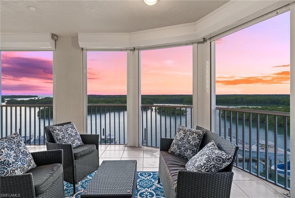 445 Dockside Drive, Unit A504 Naples, FL 34110 - Photo 24 of 50 a living room with furniture and a floor to ceiling window