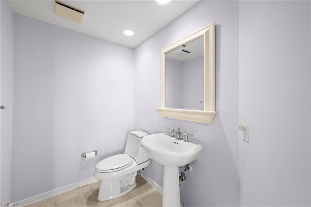 445 Dockside Drive, Unit A504 Naples, FL 34110 - Photo 30 of 50 a bathroom with a sink toilet and mirror