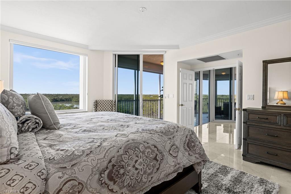 445 Dockside Drive, Unit A504 Naples, FL 34110 - Photo 33 of 50 a bedroom with a large bed and a large window