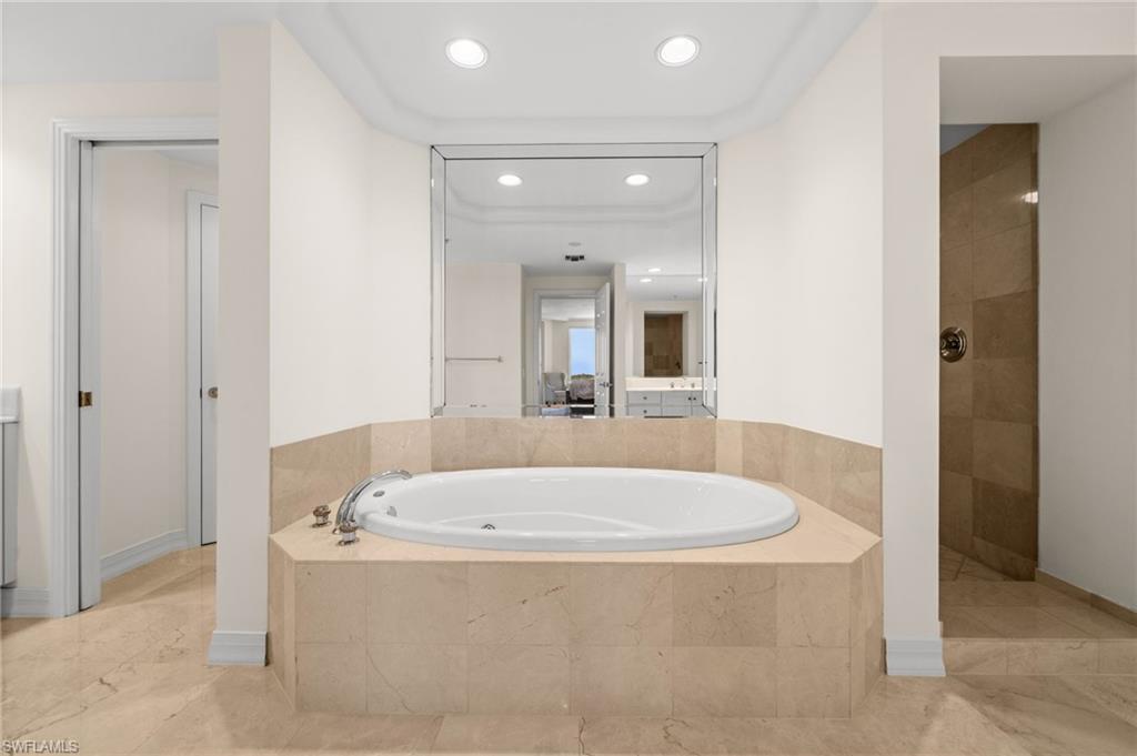 445 Dockside Drive, Unit A504 Naples, FL 34110 - Photo 37 of 50 a bathroom with a tub and a sink