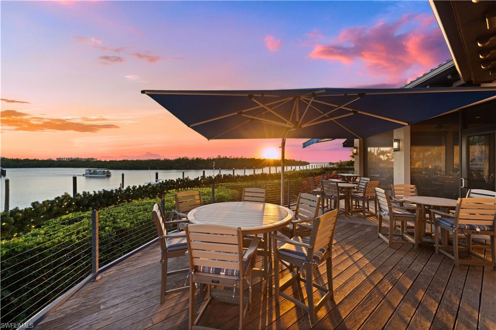 445 Dockside Drive, Unit A504 Naples, FL 34110 - Photo 39 of 50 a view of a roof deck with dining table and chairs with wooden floor