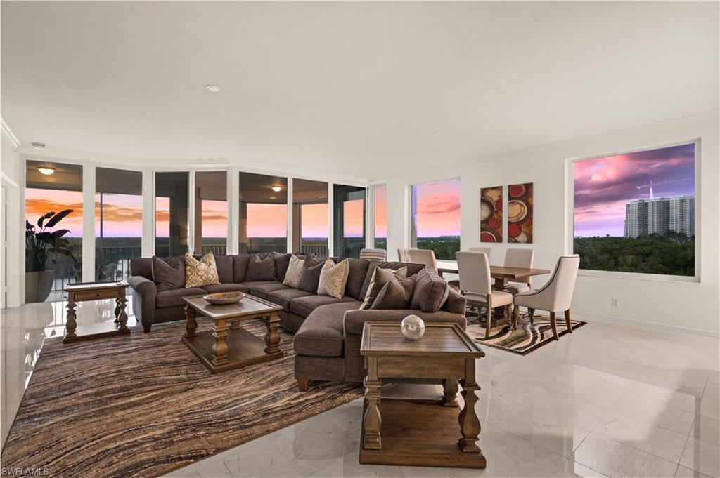 445 Dockside Drive, Unit A504 Naples, FL 34110 - Photo 5 of 50 a living room with furniture large window and flat screen tv